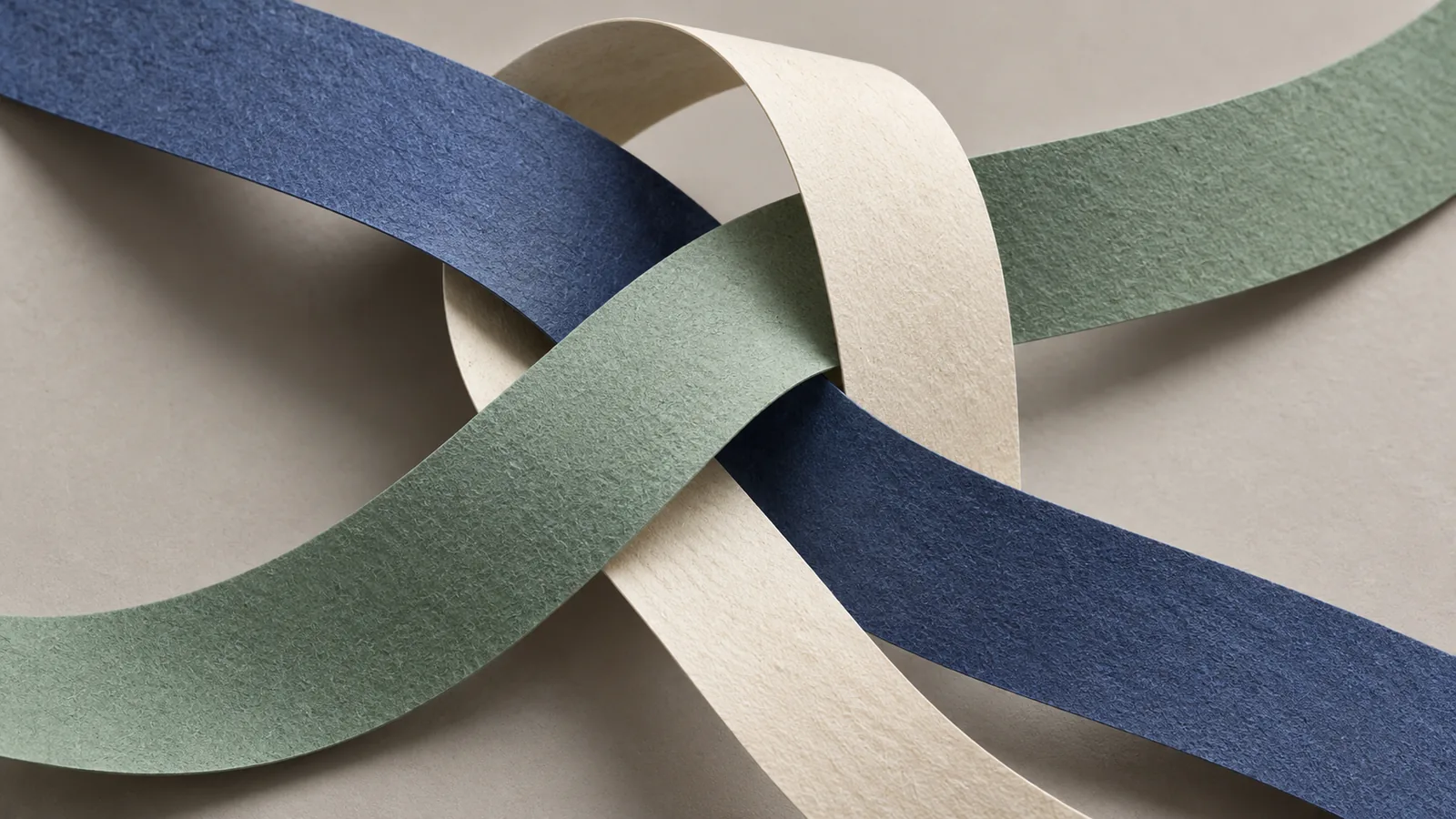 Interlocking indigo, celadon, and cream paper ribbons crossing at different heights