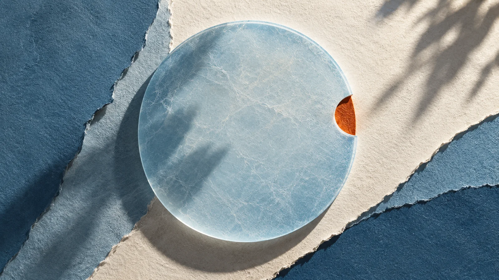 Layered pale blue paper circles interrupted by a rust-colored notch